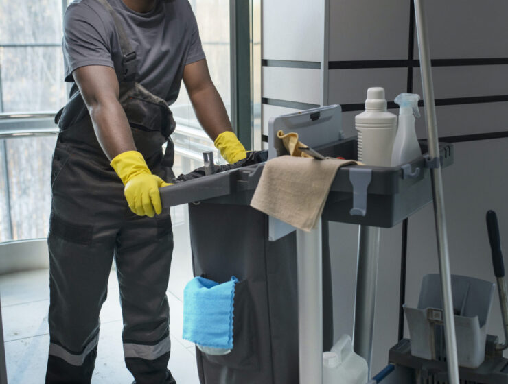 full-shot-man-walking-with-cleaning-cart