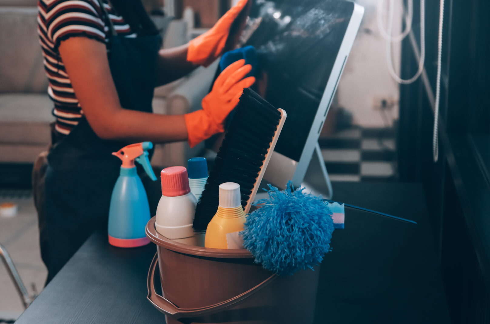 Janitor wiping table in office