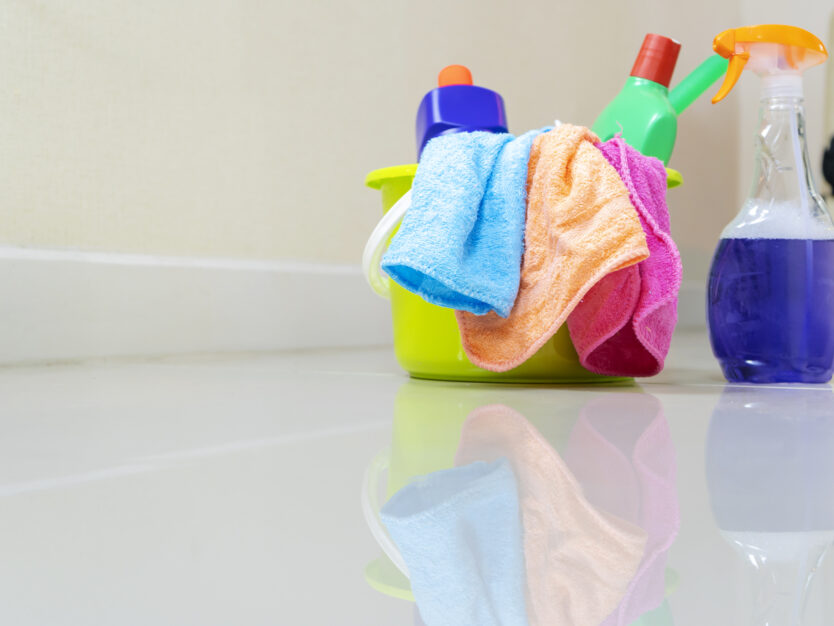 Cleaning service. Bucket with sponges, chemicals bottles and mopping stick. Rubber gloves and towel. Household equipment.